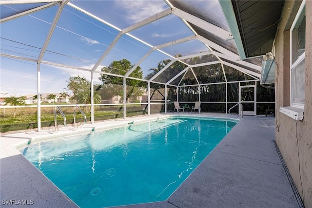 view of pool featuring a lanai and a patio