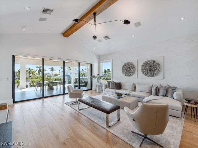 living room featuring beamed ceiling, light wood-type flooring, and high vaulted ceiling