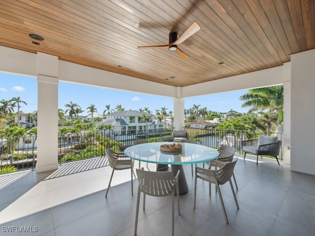 view of patio with ceiling fan and a water view