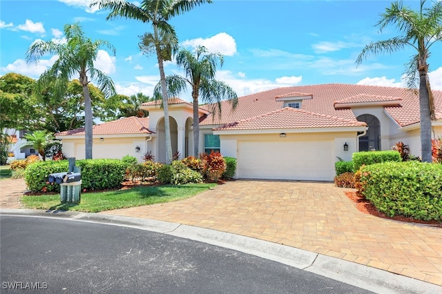 mediterranean / spanish home featuring a garage