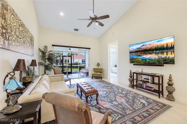 tiled living room featuring ceiling fan and high vaulted ceiling