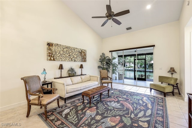 tiled living room featuring ceiling fan and high vaulted ceiling