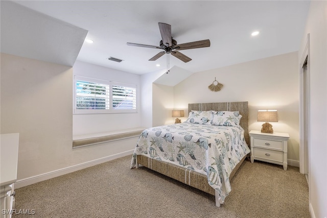 bedroom featuring light colored carpet, vaulted ceiling, and ceiling fan