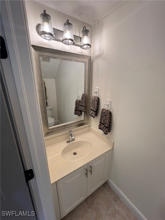 bathroom with tile patterned floors, vanity, and toilet