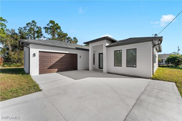 view of front facade with a garage and a front lawn