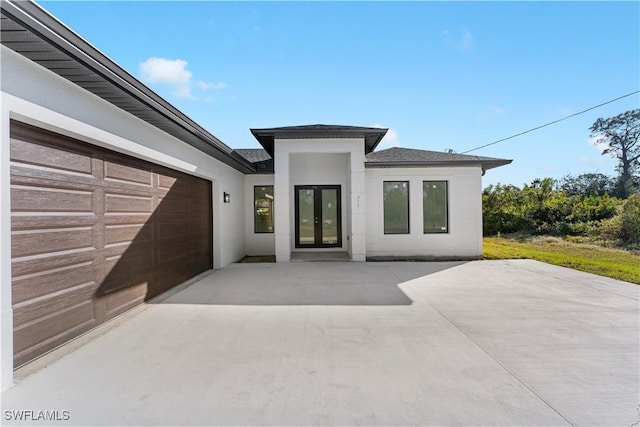 exterior space with a garage and french doors