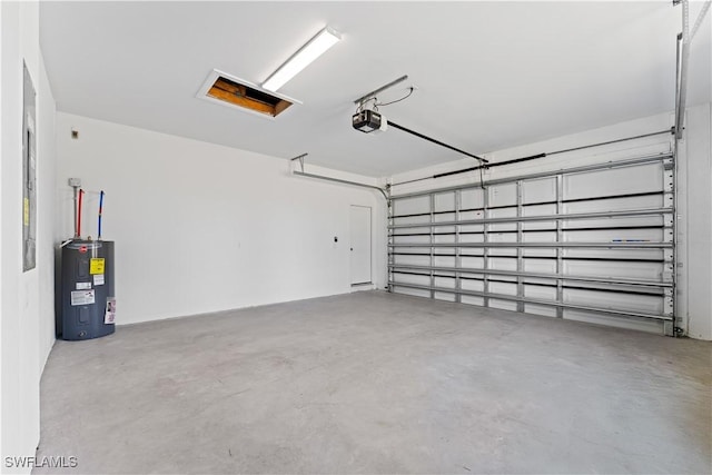 garage featuring a garage door opener and electric water heater