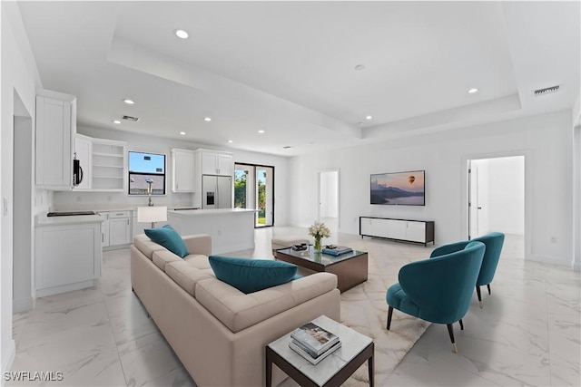 living room featuring a tray ceiling