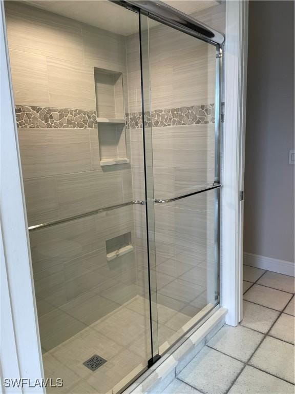 bathroom with tile patterned floors and a shower with shower door