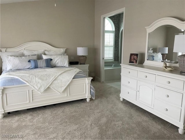 carpeted bedroom featuring ensuite bathroom