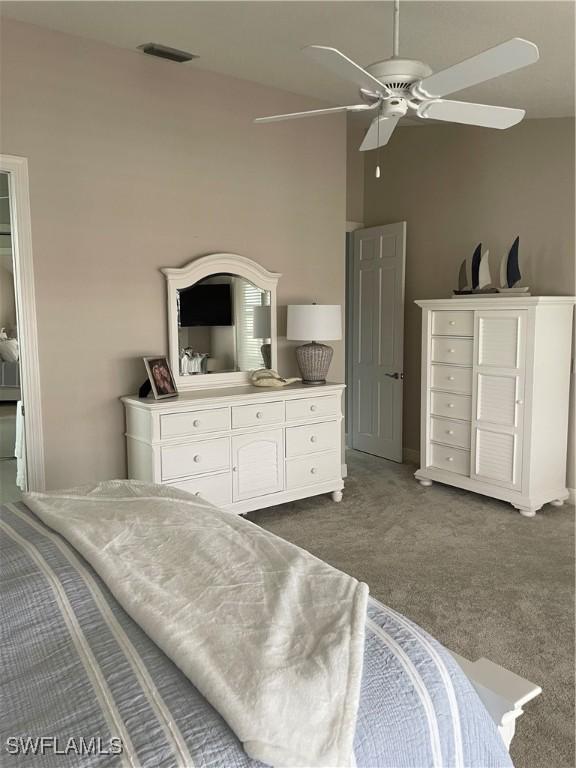 bedroom featuring dark carpet and ceiling fan