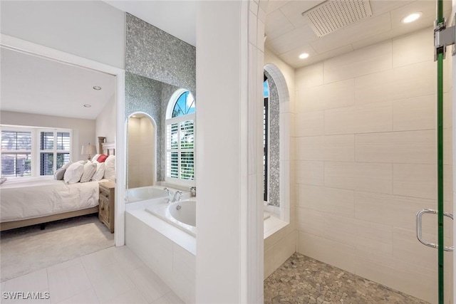 bathroom featuring tile patterned flooring, separate shower and tub, and a wealth of natural light