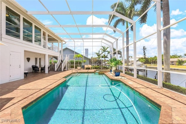 view of swimming pool with a patio area and glass enclosure