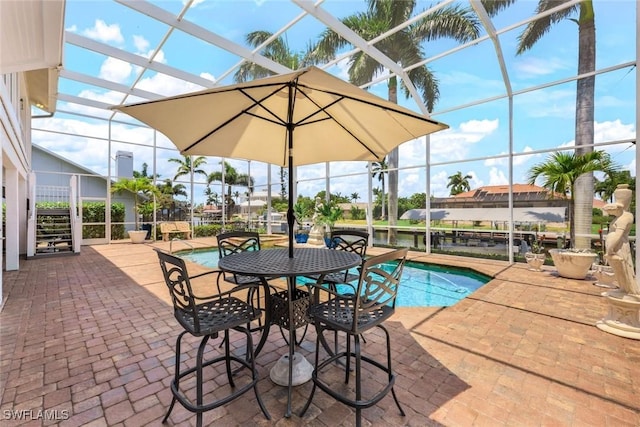 view of swimming pool featuring a lanai and a patio