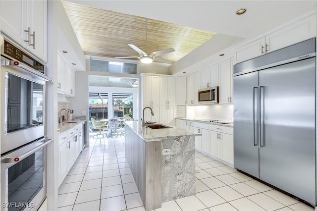 kitchen with stainless steel appliances, sink, and white cabinets