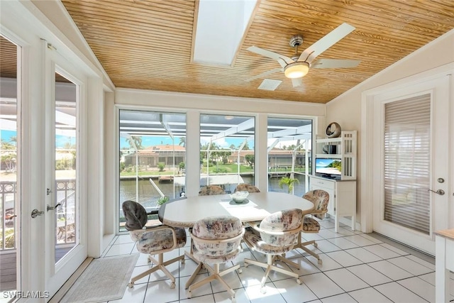 sunroom with wood ceiling, vaulted ceiling with skylight, french doors, and ceiling fan