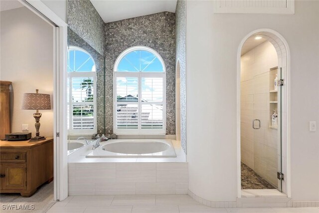 bathroom featuring tile patterned flooring and shower with separate bathtub