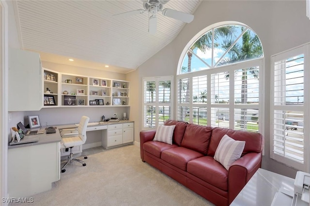 carpeted home office featuring built in desk, high vaulted ceiling, and ceiling fan