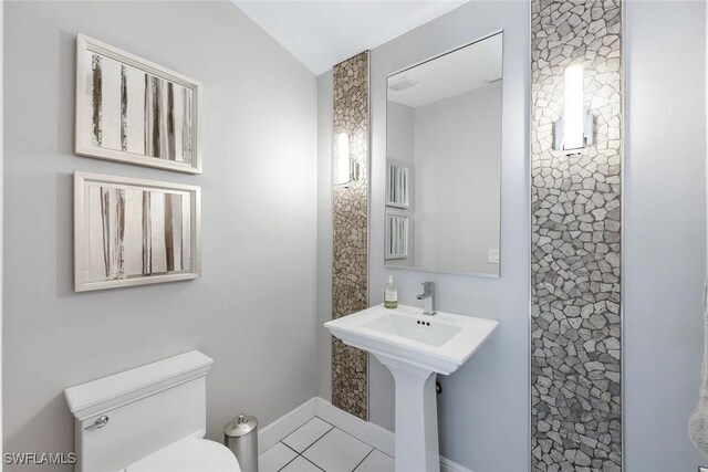 bathroom with tile patterned flooring and toilet