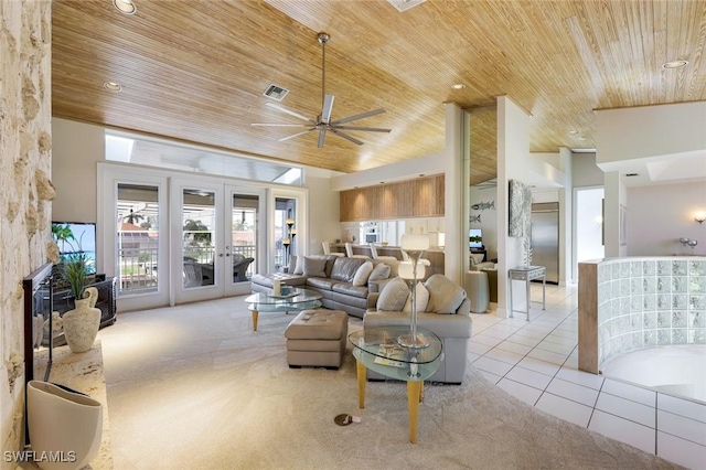 tiled living room with french doors, ceiling fan, a towering ceiling, and wooden ceiling