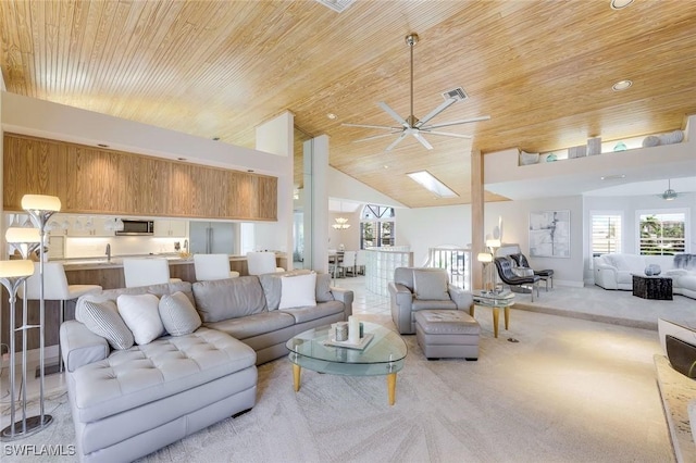 living room with sink, wood ceiling, ceiling fan, high vaulted ceiling, and light colored carpet