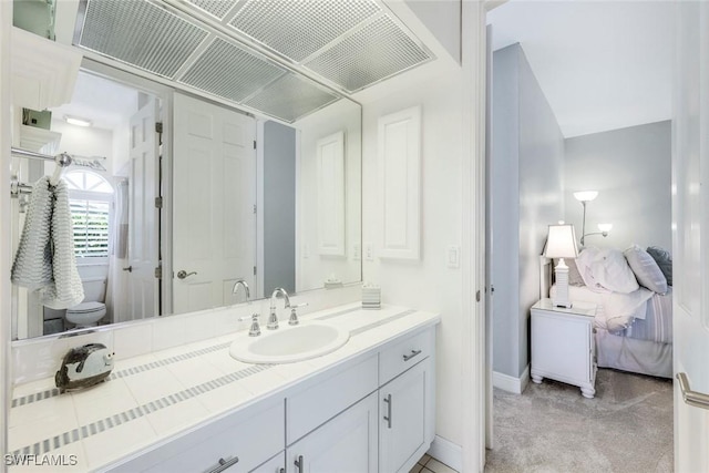 bathroom with vanity and toilet