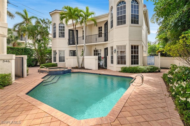 view of pool with a community hot tub and a patio area