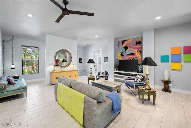 living room featuring light hardwood / wood-style flooring and ceiling fan