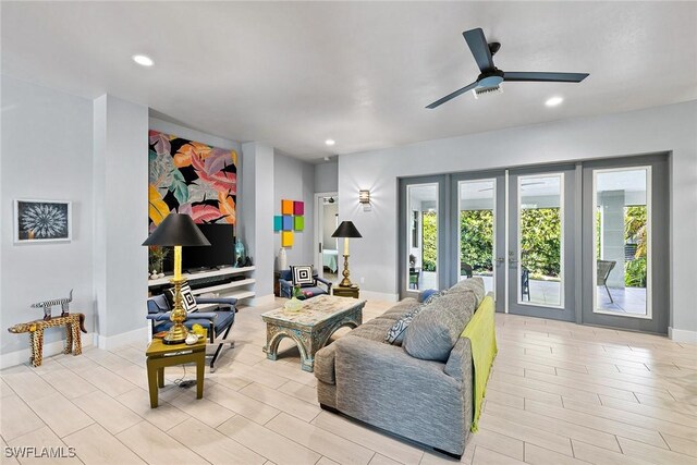 living room featuring ceiling fan and french doors