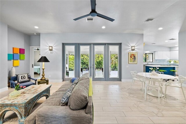 living room featuring ceiling fan and french doors