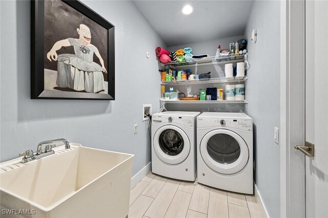 laundry room with washer and dryer and sink