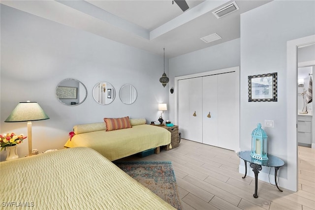 bedroom with a tray ceiling and a closet