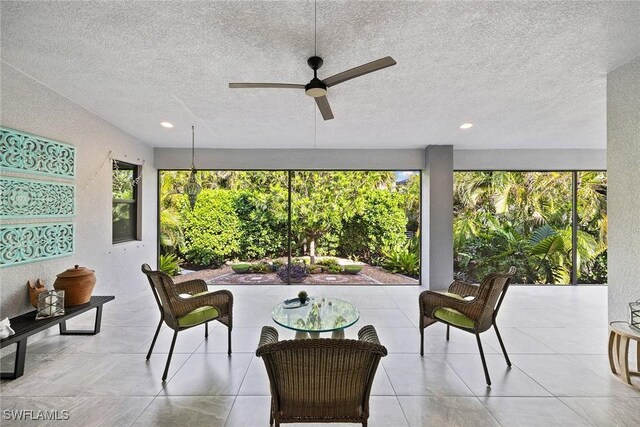 sunroom with ceiling fan