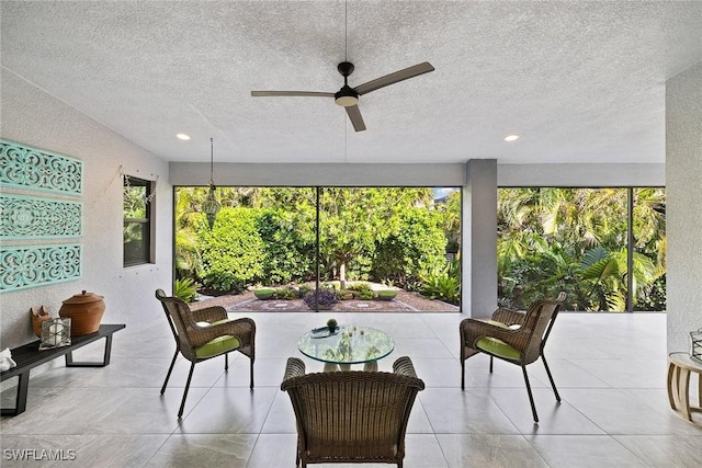 sunroom / solarium featuring ceiling fan