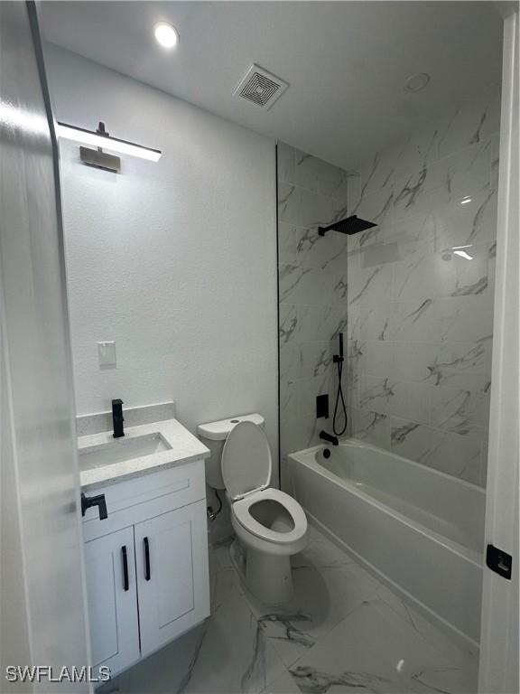 full bathroom featuring vanity, toilet, and tiled shower / bath