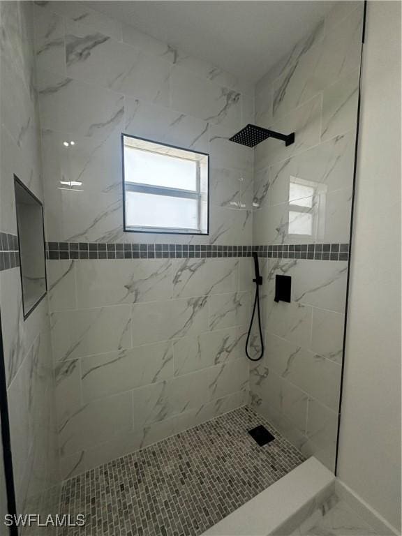 bathroom with tiled shower