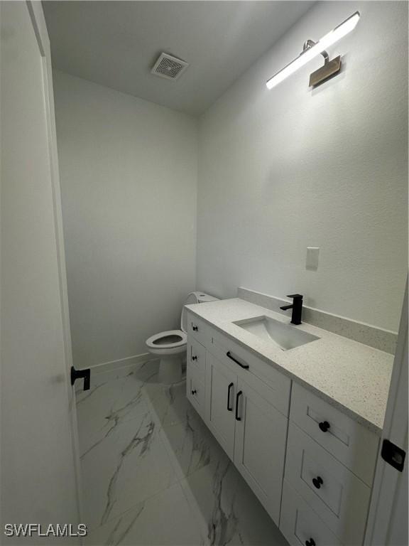 bathroom with vanity and toilet