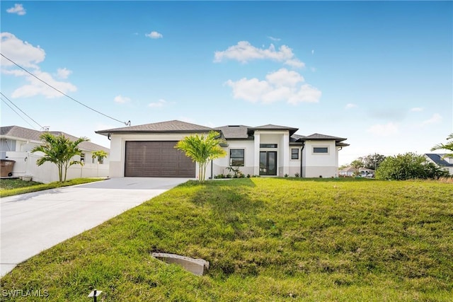 view of front of house featuring a front lawn and a garage