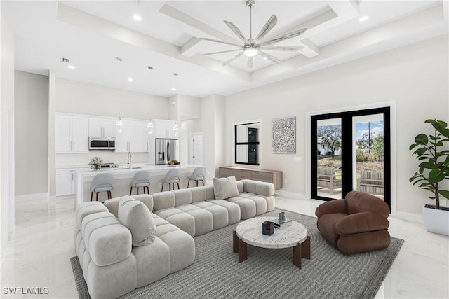 living room with ceiling fan, sink, a high ceiling, and coffered ceiling