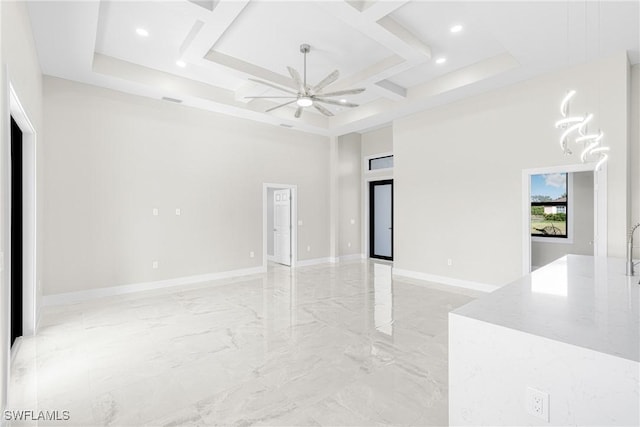 unfurnished room with ceiling fan and a high ceiling