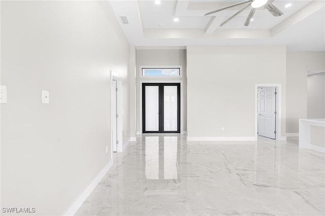 entryway featuring ceiling fan and a high ceiling