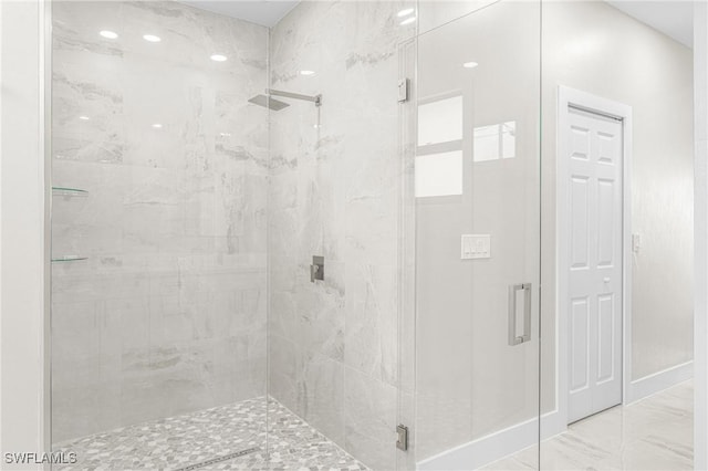 bathroom featuring a shower with door