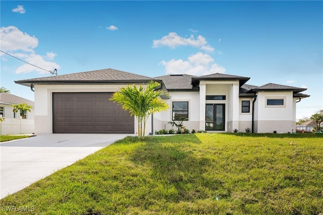 view of front of property with a garage and a front lawn