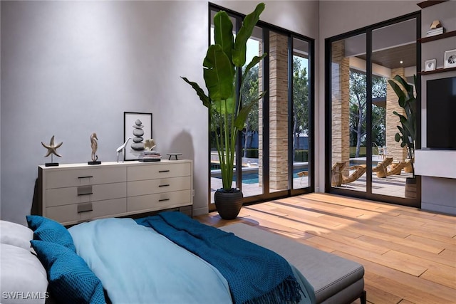 bedroom featuring access to exterior and light hardwood / wood-style floors