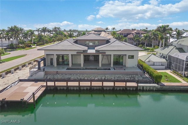 back of house with a patio area and a water view