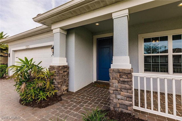 property entrance with a porch and a garage