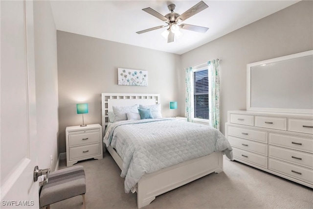 bedroom with light carpet and ceiling fan