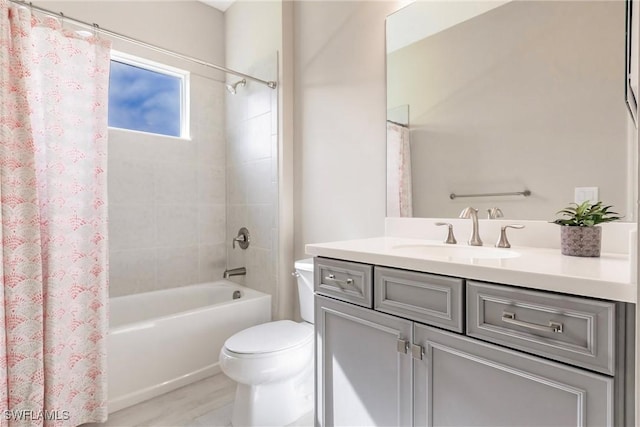 full bathroom featuring vanity, shower / tub combo, and toilet