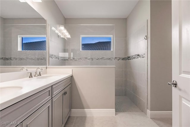 bathroom featuring tile patterned floors, vanity, and tiled shower