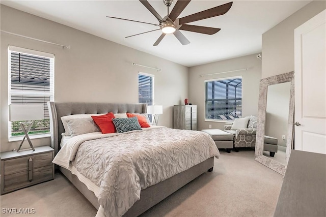 bedroom with ceiling fan and light colored carpet